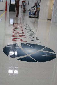 Precision Installations logo on show room floor Precision Installations logo on show room floor