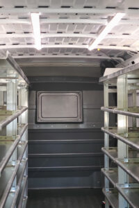 Custom metal shelving installed inside commercial van Custom metal shelving installed inside commercial van