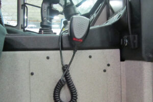 Whelen walkie talkie hangs from middle console of emergency vehicle Whelen walkie talkie hangs from middle console of emergency vehicle