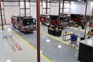 Emergency vehicles being upfitted at workstations Emergency vehicles being upfitted at workstations