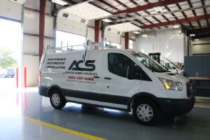 White utility van parked in workstation with upfitting White utility van parked in workstation with upfitting