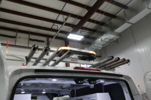 Weather Guard rack with LED lights installed on top of a white commercial van inside workstation Weather Guard rack with LED lights installed on top of a white commercial van inside workstation