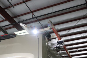 Rigid external lighting install next to ladder storage on outside of white commercial van Rigid external lighting install next to ladder storage on outside of white commercial van
