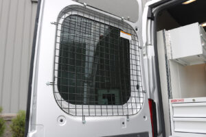 Commercial van with installed window safety screen pared outside with door open Commercial van with installed window safety screen pared outside with door open