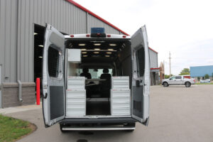 Commercial van parked outside with custom weather guard shelving Commercial van parked outside with custom weather guard shelving